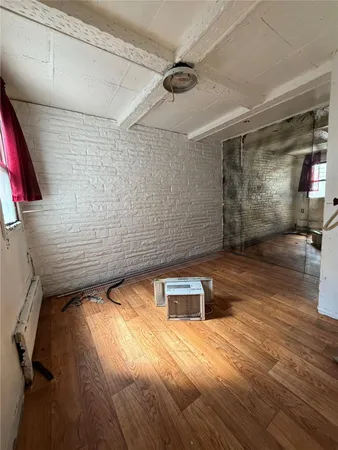 a view of a room with wooden floor