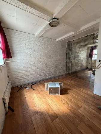 a view of a room with wooden floor
