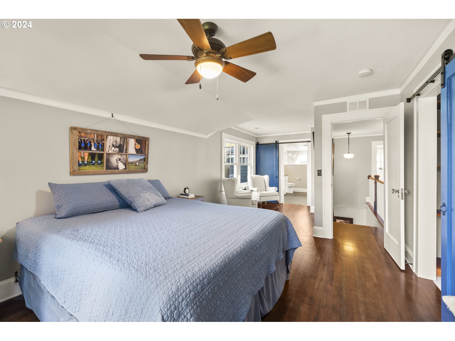 3029 Southwest Sunset Boulevard Portland, OR 97239 - Photo 13 of 48 a bedroom with a large bed and a chandelier