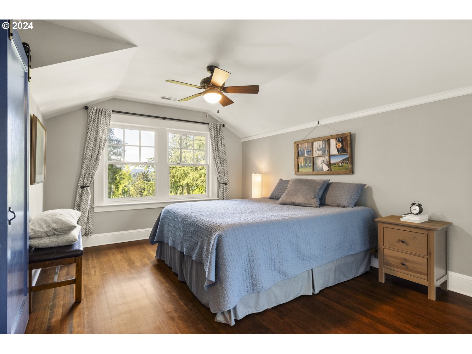 3029 Southwest Sunset Boulevard Portland, OR 97239 - Photo 14 of 48 a bedroom with a bed and wooden floor