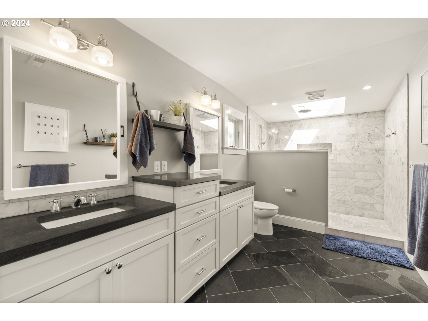 3029 Southwest Sunset Boulevard Portland, OR 97239 - Photo 17 of 48 a bathroom with a granite countertop sink a toilet and a mirror