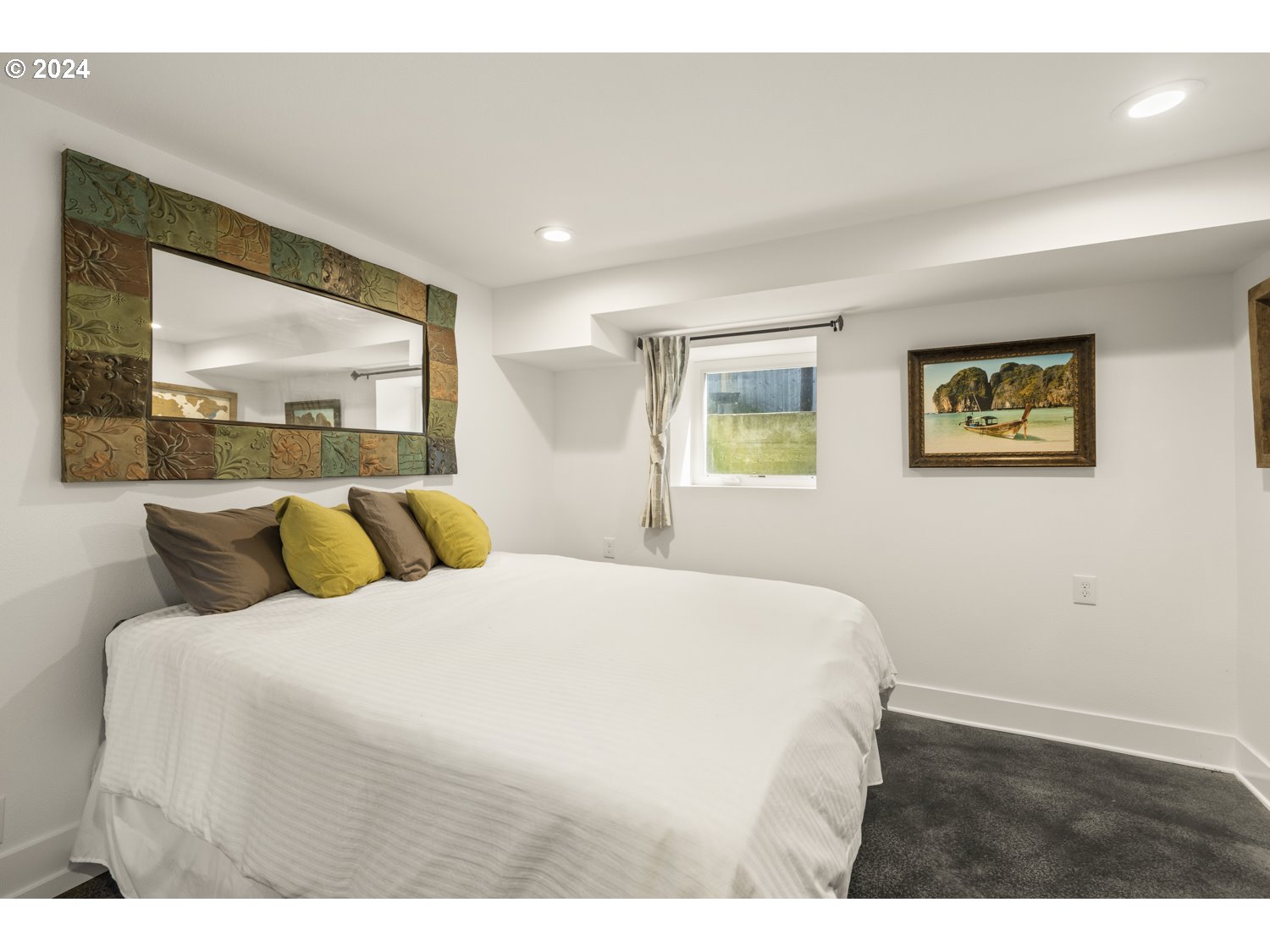 3029 Southwest Sunset Boulevard Portland, OR 97239 - Photo 26 of 48 a bedroom with a bed and a large mirror