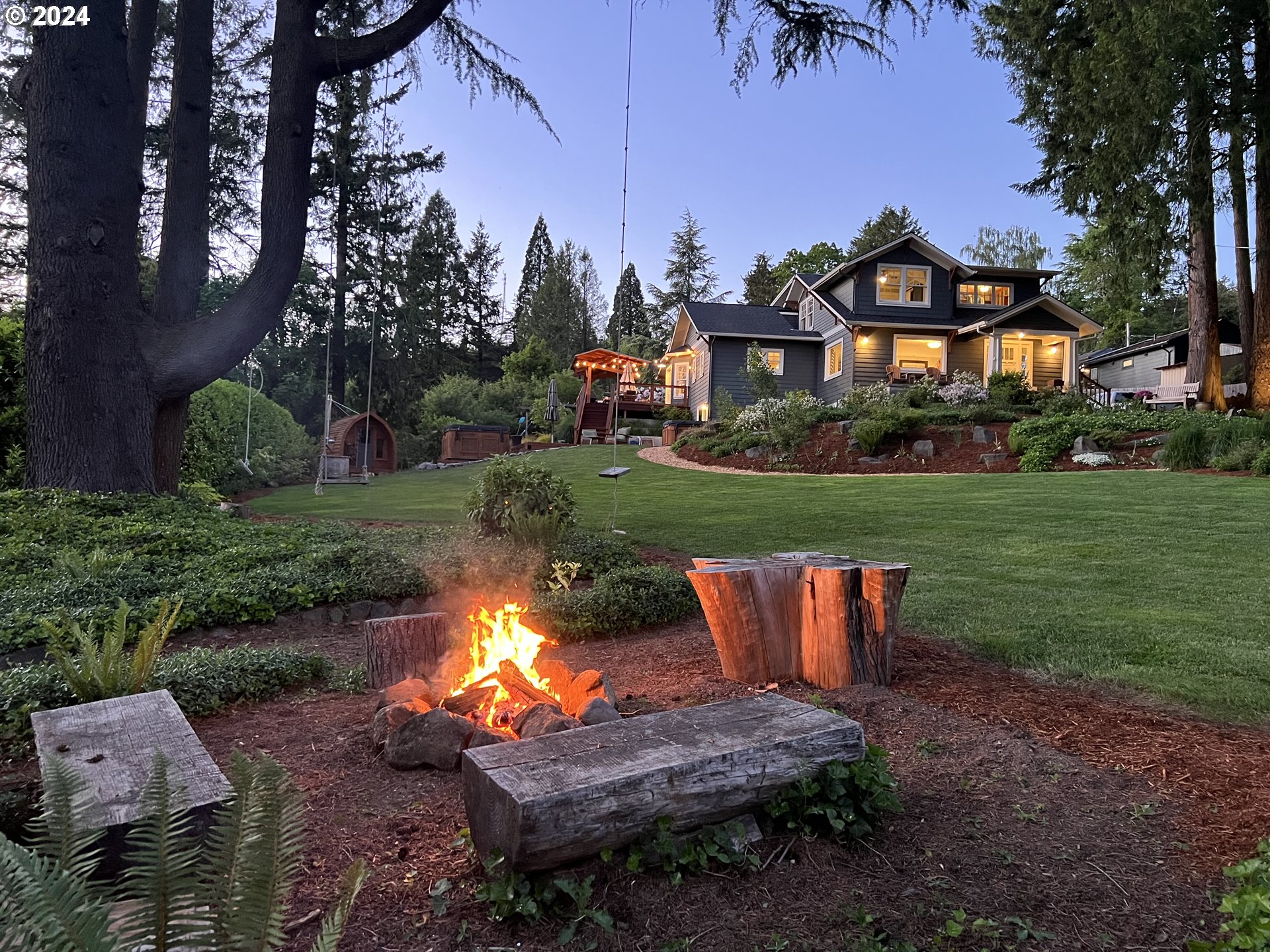 3029 Southwest Sunset Boulevard Portland, OR 97239 - Photo 3 of 48 a backyard of a house with table and chairs