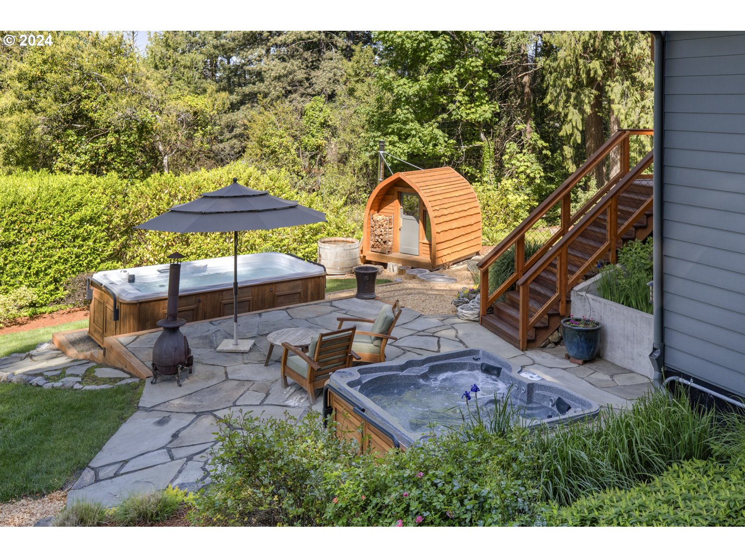 3029 Southwest Sunset Boulevard Portland, OR 97239 - Photo 31 of 48 a backyard of a house with table and chairs