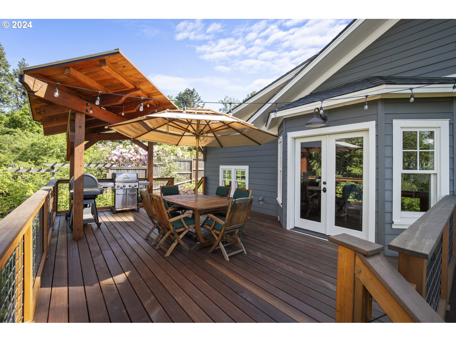 3029 Southwest Sunset Boulevard Portland, OR 97239 - Photo 36 of 48 a view of a patio with table and chairs with wooden floor and fence