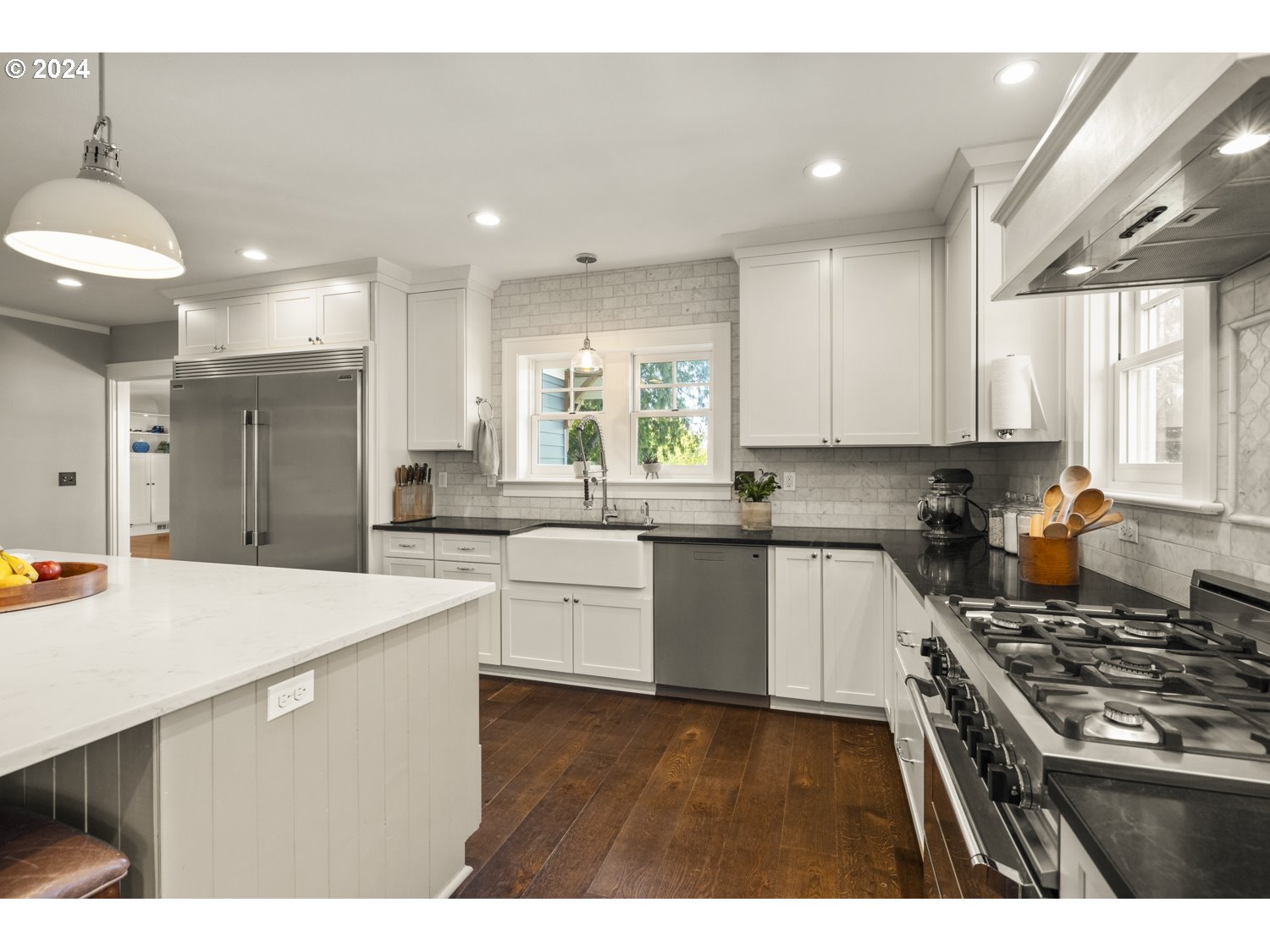 3029 Southwest Sunset Boulevard Portland, OR 97239 - Photo 9 of 48 a kitchen with stainless steel appliances granite countertop a sink stove and refrigerator