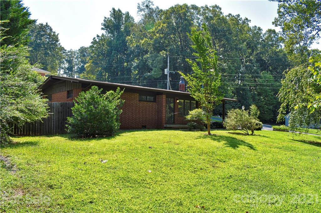 700 Mountain Creek Road Albemarle, NC 28001 - Photo 1 of 48 a view of a backyard with potted plants and large trees