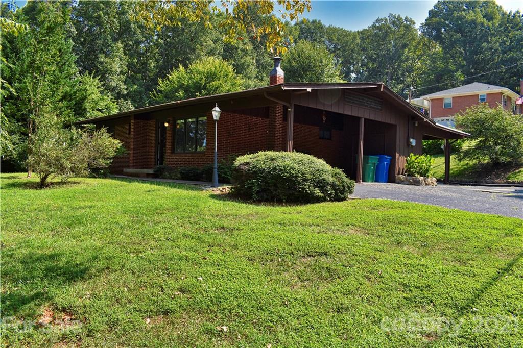700 Mountain Creek Road Albemarle, NC 28001 - Photo 2 of 48 a house with green field in front of it