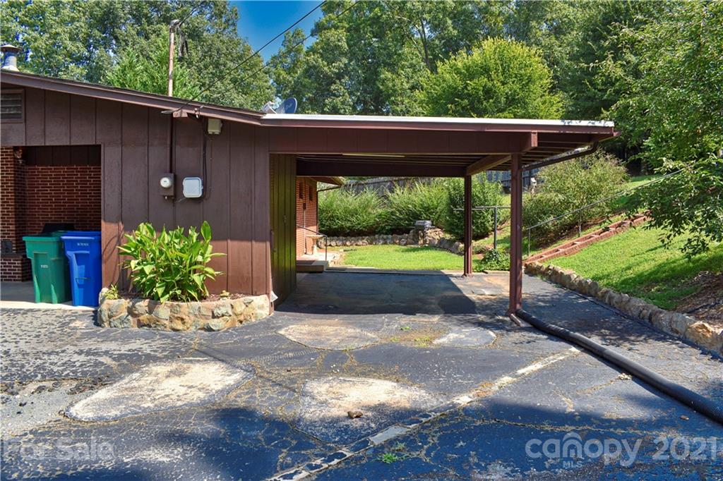 700 Mountain Creek Road Albemarle, NC 28001 - Photo 16 of 48 a view of a patio with table and chairs potted plants with wooden floor