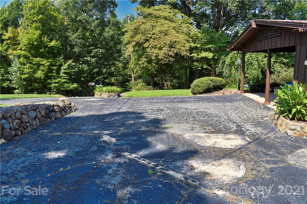 700 Mountain Creek Road Albemarle, NC 28001 - Photo 18 of 48 a view of a backyard with a garden and trees