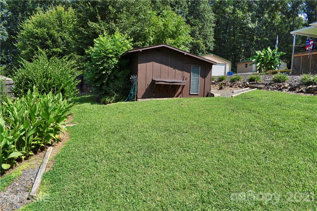 700 Mountain Creek Road Albemarle, NC 28001 - Photo 21 of 48 a yellow house with tall trees in the background