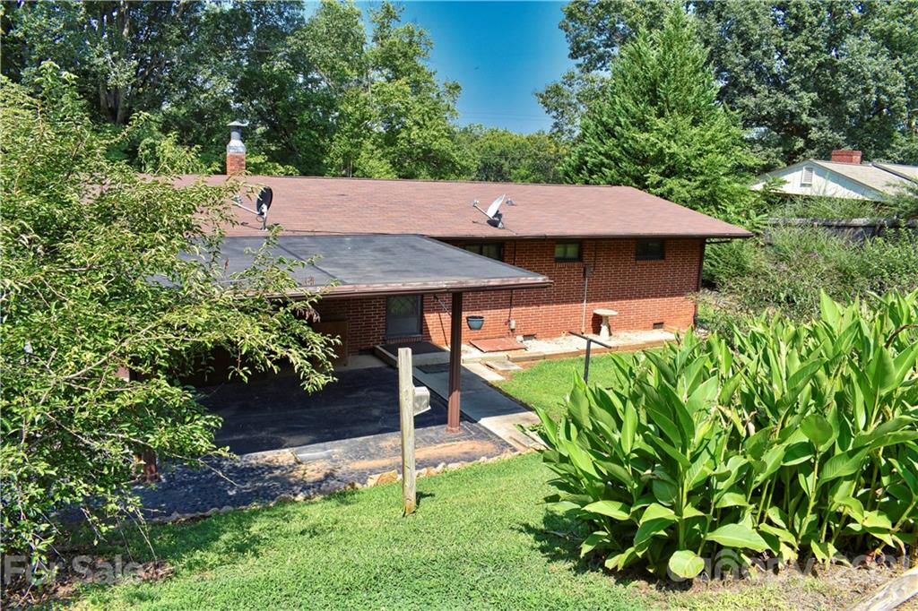 700 Mountain Creek Road Albemarle, NC 28001 - Photo 22 of 48 a view of a backyard with table and chairs potted plants