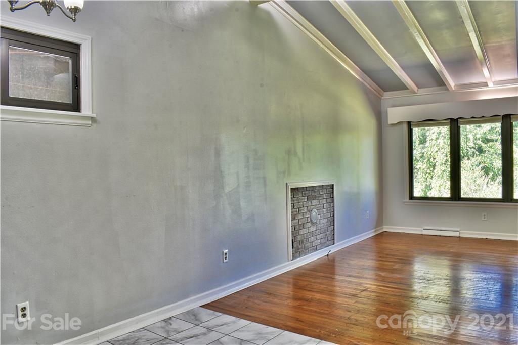 700 Mountain Creek Road Albemarle, NC 28001 - Photo 26 of 48 an empty room with wooden floor and windows