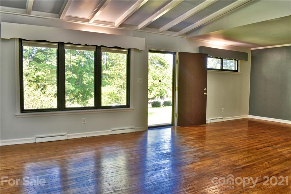 700 Mountain Creek Road Albemarle, NC 28001 - Photo 28 of 48 a view of an empty room with wooden floor and a window