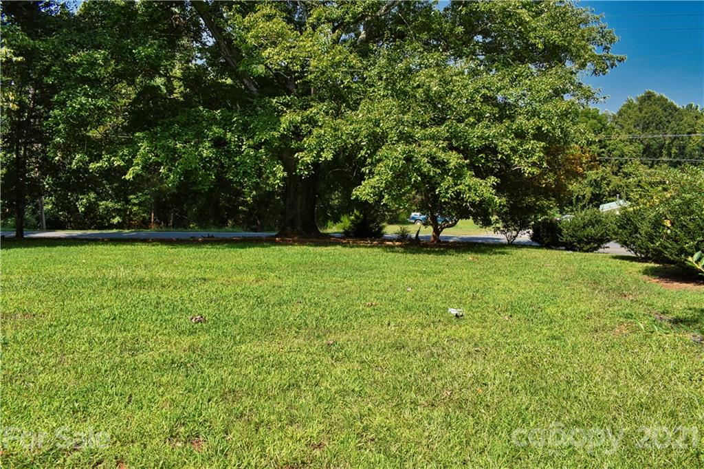 700 Mountain Creek Road Albemarle, NC 28001 - Photo 30 of 48 a view of a grassy field with trees