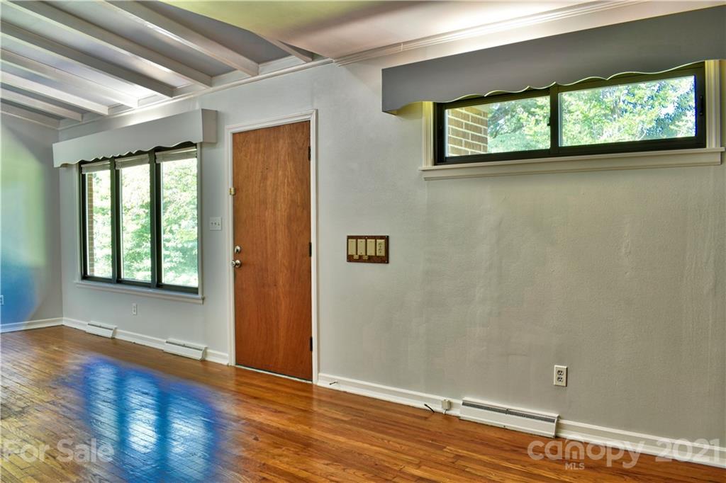 700 Mountain Creek Road Albemarle, NC 28001 - Photo 36 of 48 an empty room with wooden floor and windows