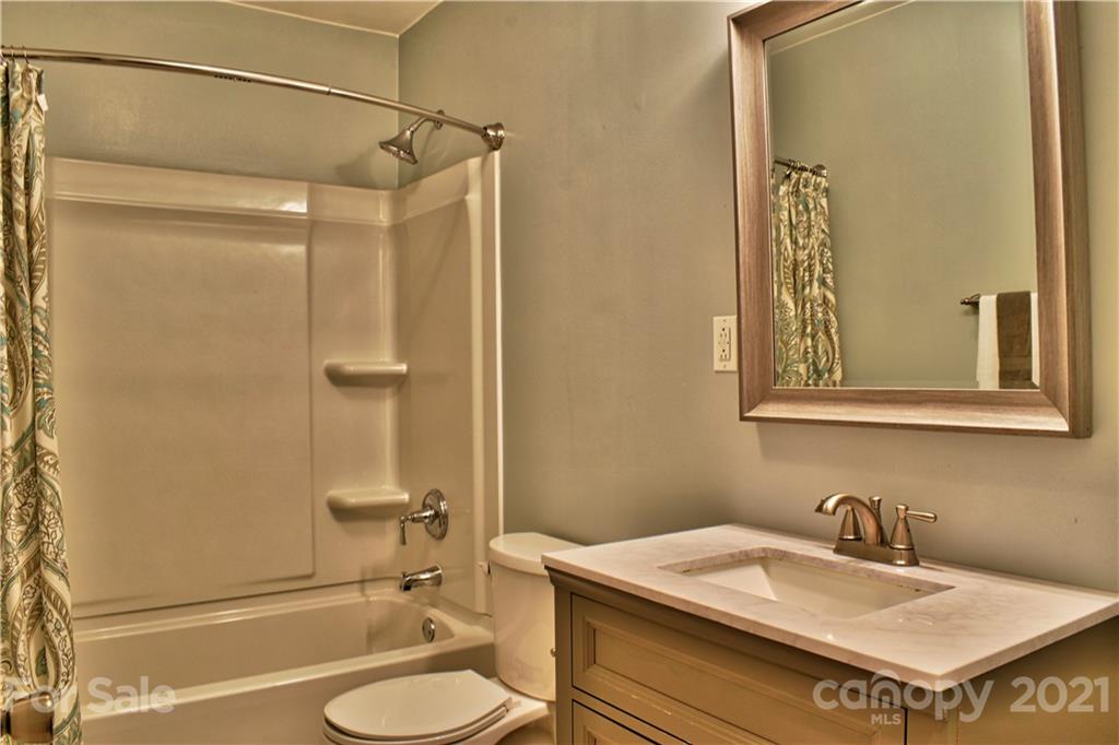 700 Mountain Creek Road Albemarle, NC 28001 - Photo 37 of 48 a bathroom with a granite countertop sink toilet and shower