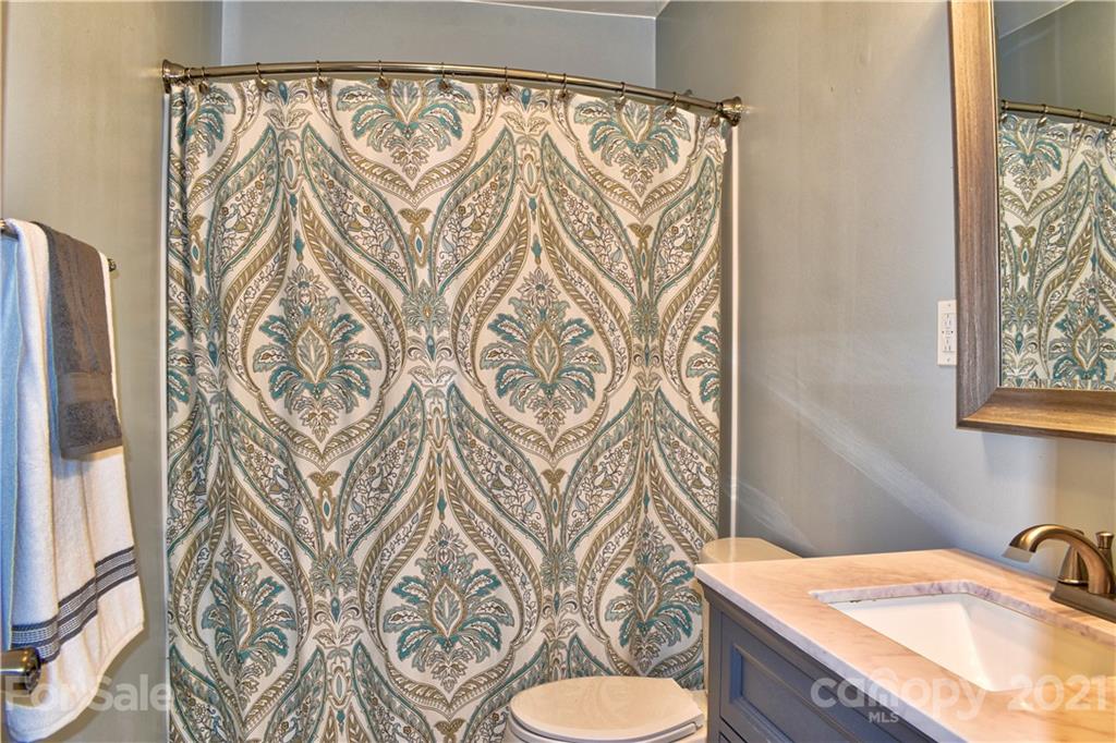 700 Mountain Creek Road Albemarle, NC 28001 - Photo 38 of 48 a bathroom with a granite countertop sink and a mirror