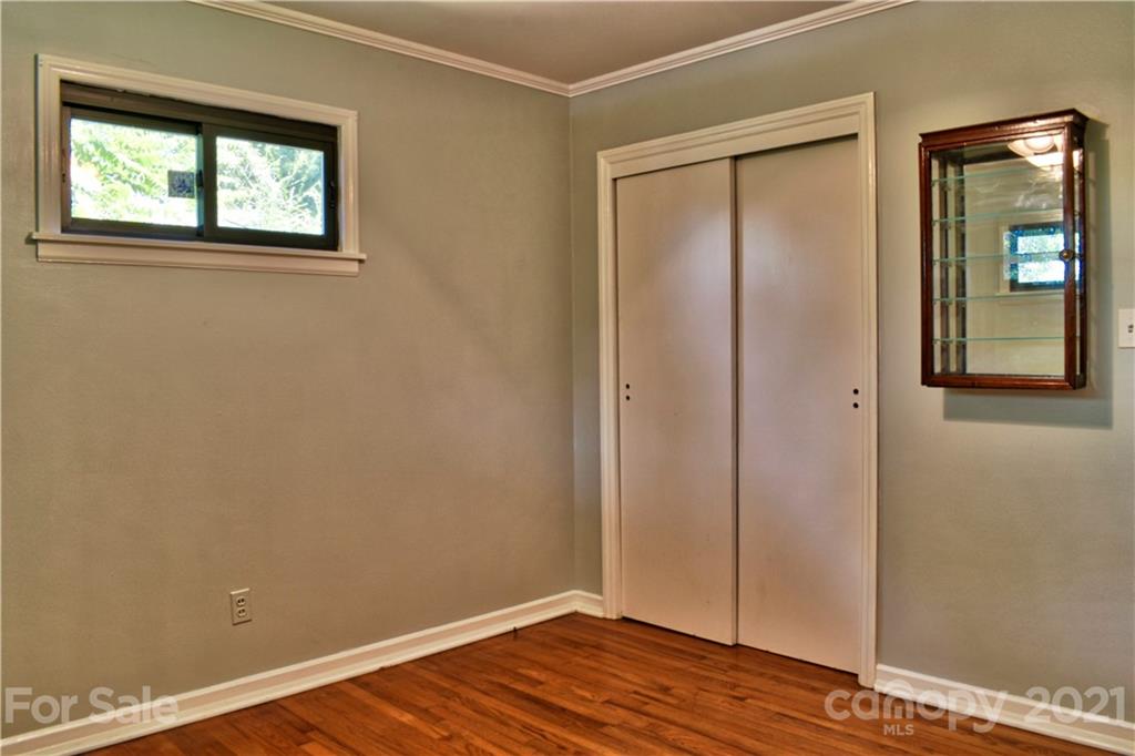 700 Mountain Creek Road Albemarle, NC 28001 - Photo 41 of 48 an empty room with wooden floor and windows