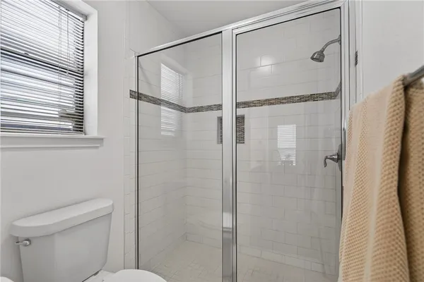 a bathroom with a shower and a toilet