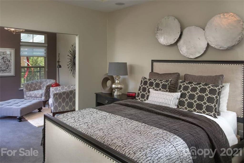 2070 New Style Way, Unit 39 Tega Cay, SC 29708 - Photo 9 of 12 a bedroom with a large bed and wooden floor