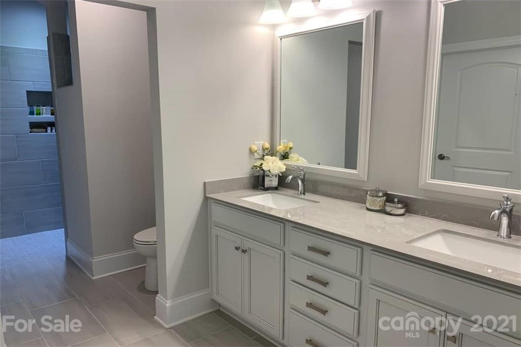 2070 New Style Way, Unit 39 Tega Cay, SC 29708 - Photo 10 of 12 a bathroom with a double vanity sink and a mirror