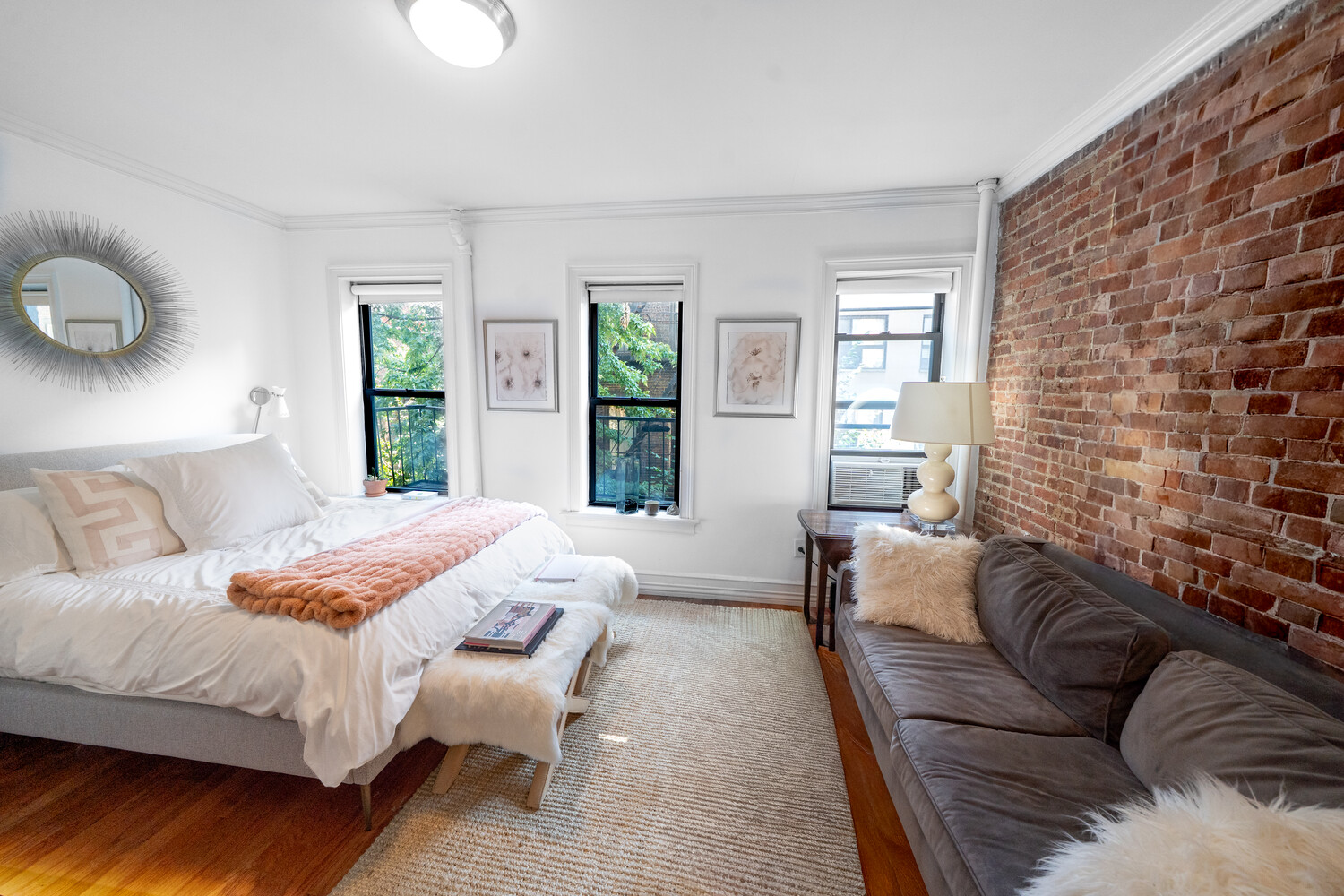 a bedroom with a bed couch and window