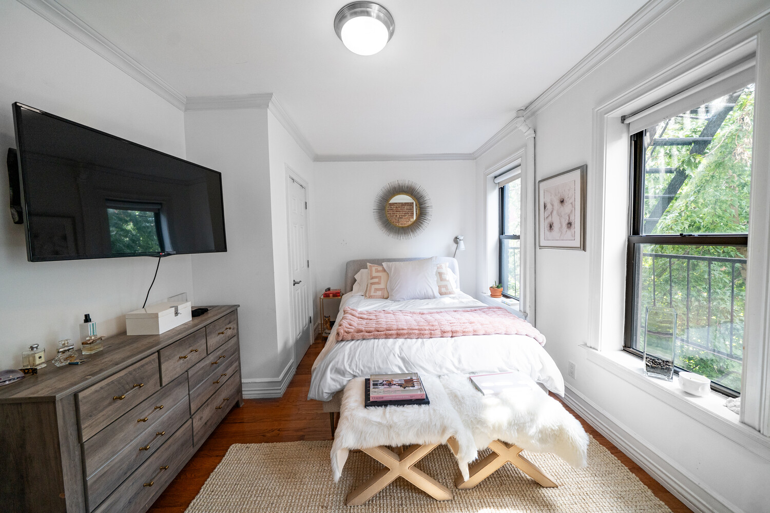 236 East 78th Street, Unit 4B Manhattan, NY 10075 - Photo 2 of 11 a bedroom with a large bed and a flat tv screen on dresser