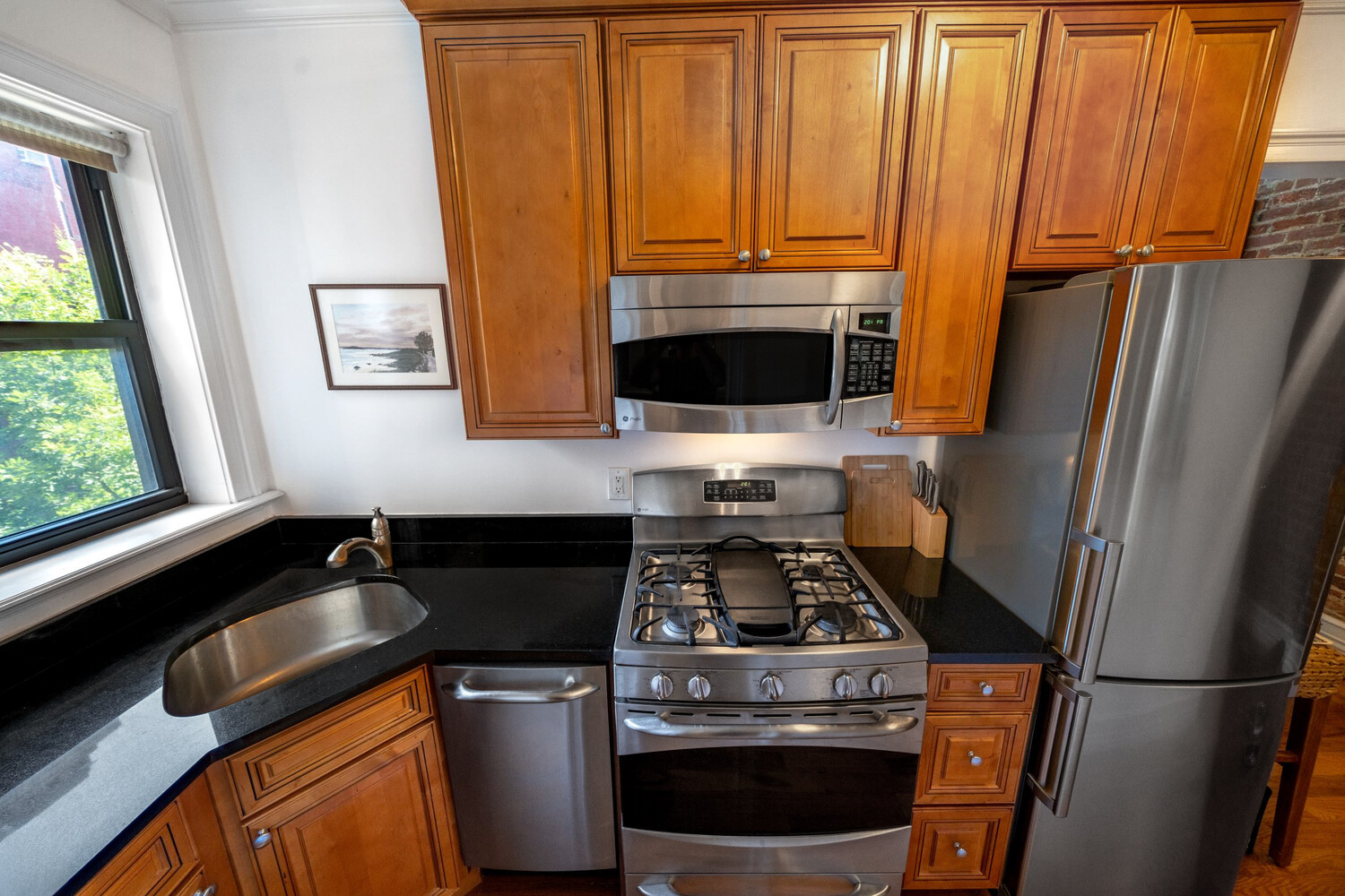 236 East 78th Street, Unit 4B Manhattan, NY 10075 - Photo 3 of 11 a kitchen with a refrigerator stove and sink