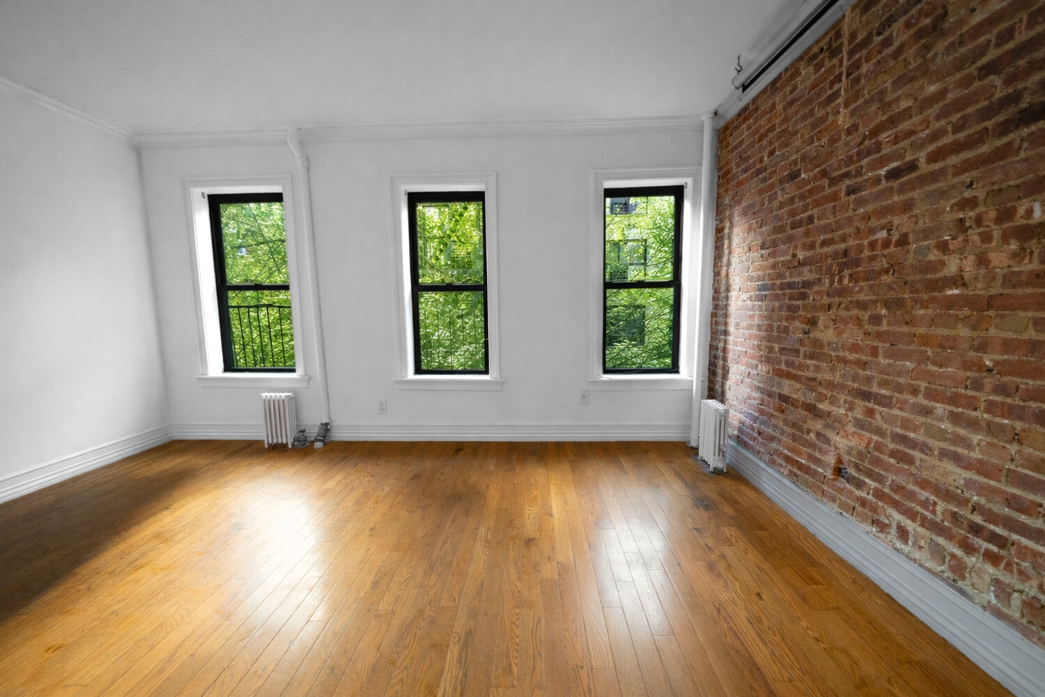 236 East 78th Street, Unit 4B Manhattan, NY 10075 - Photo 7 of 11 a view of an empty room with wooden floor and a window