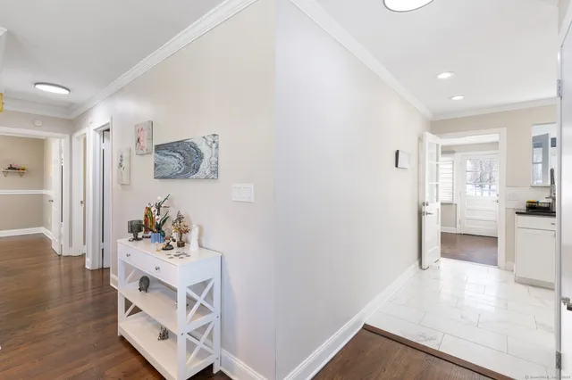 a view of a hallway with cabinet and wooden floor