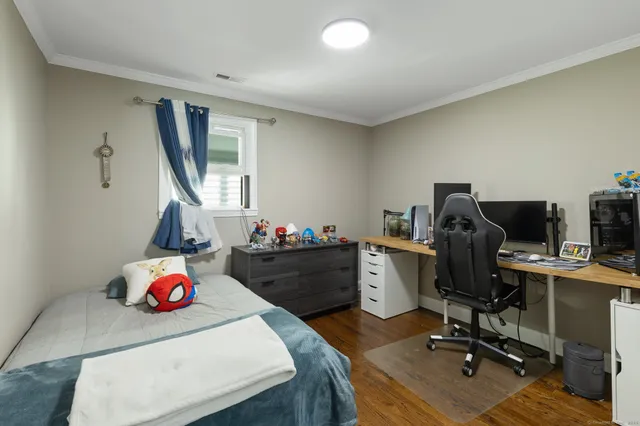 a bedroom with a workspace