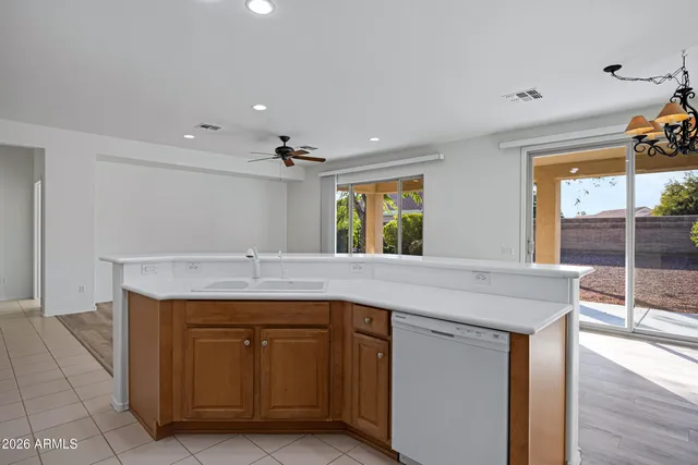 a kitchen with kitchen island a sink stainless steel appliances and window