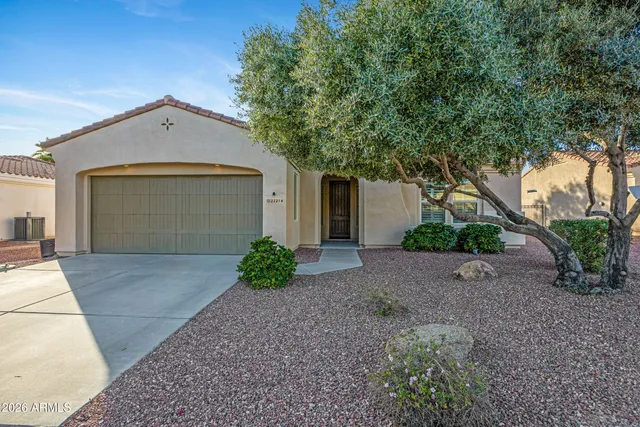 a view of a house with a yard and garage