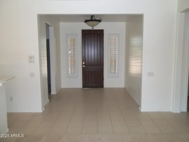 a view of a hallway to rooms