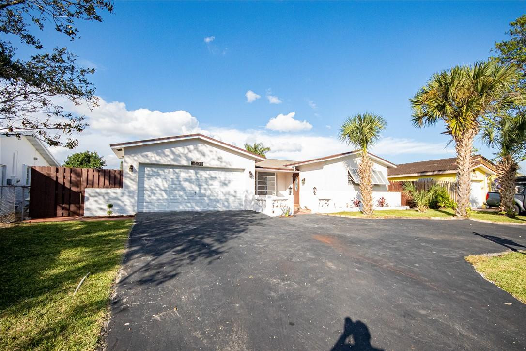 5409 West Park Road Hollywood, FL 33021 - Photo 54 of 64 a view of a house with a yard and garage