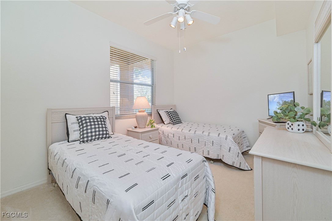 14121 Brant Point Circle, Unit 1202 Fort Myers, FL 33919 - Photo 20 of 47 a bedroom with a bed and a chandelier