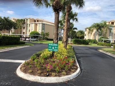 14121 Brant Point Circle, Unit 1202 Fort Myers, FL 33919 - Photo 2 of 47 a view of a house with a yard and palm trees