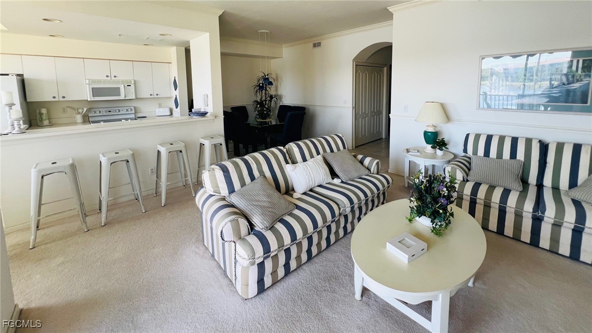 14121 Brant Point Circle, Unit 1202 Fort Myers, FL 33919 - Photo 6 of 47 a living room with furniture kitchen and a table