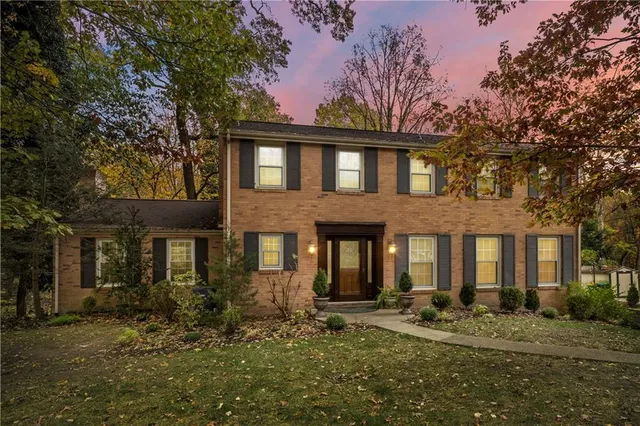 a front view of a house with yard and seating area