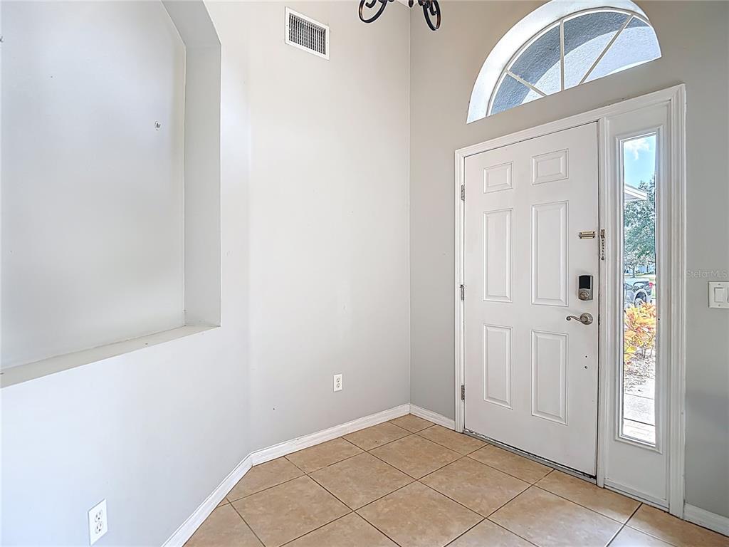 12153 South Bridge Terrace Hudson, FL 34669 - Photo 14 of 60 a view of an entryway with wooden floor