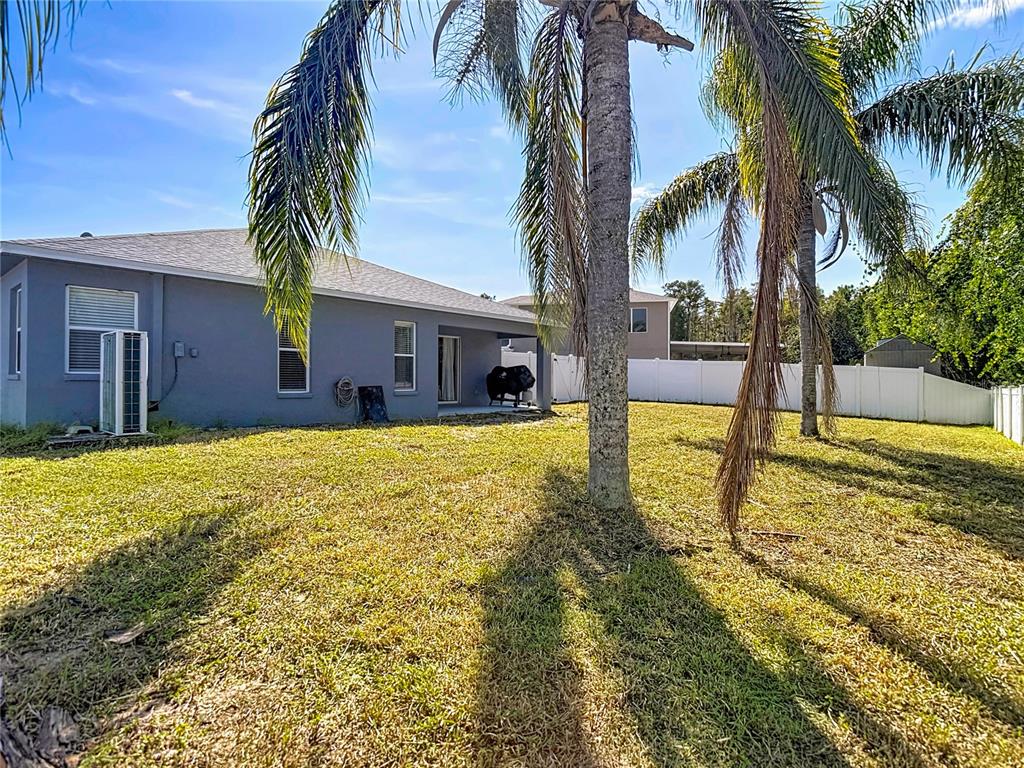 12153 South Bridge Terrace Hudson, FL 34669 - Photo 19 of 60 a swimming pool with yard and outdoor seating