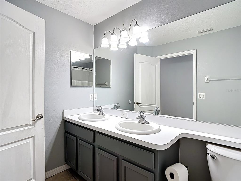12153 South Bridge Terrace Hudson, FL 34669 - Photo 26 of 60 a bathroom with a sink and a mirror