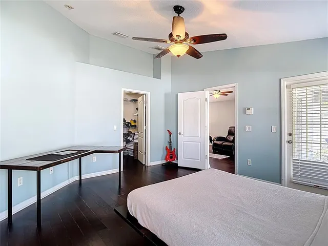 a bedroom with a bed a window and flowerpot