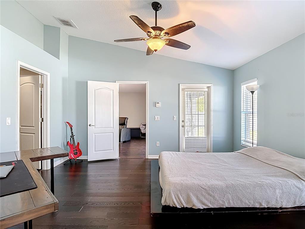 12153 South Bridge Terrace Hudson, FL 34669 - Photo 31 of 60 a bedroom that has a bed and a chandelier