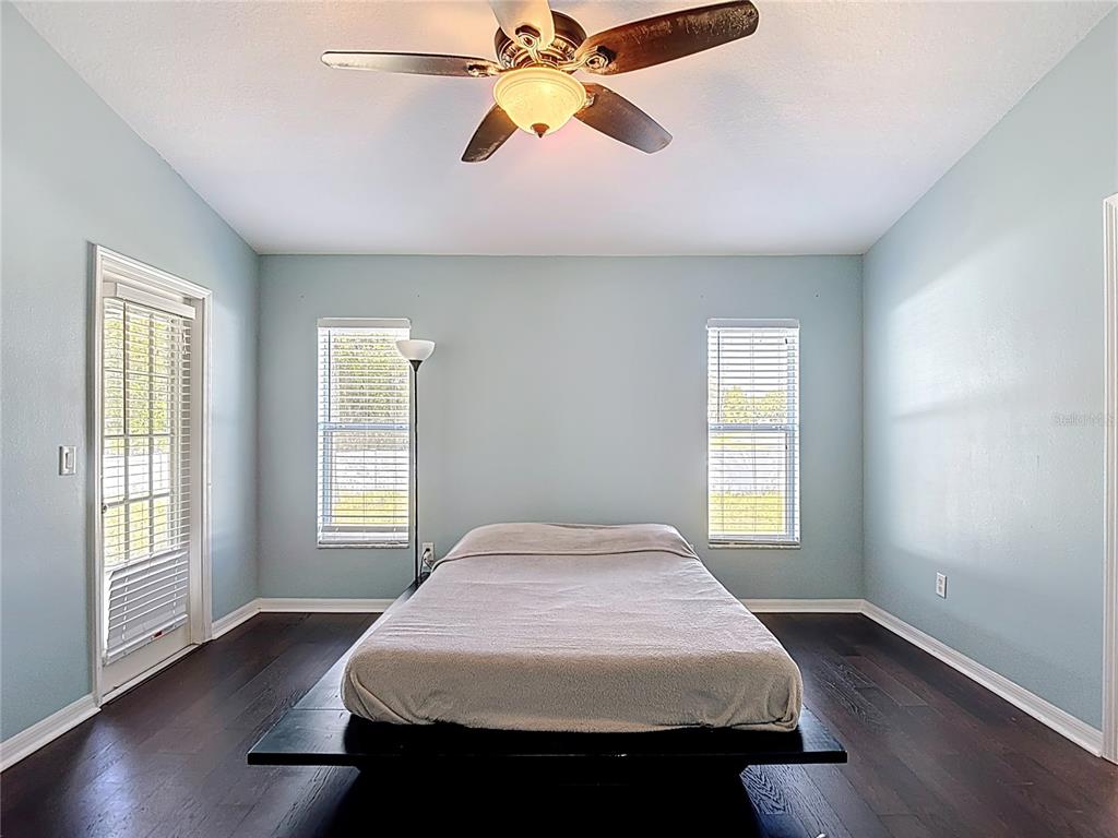 12153 South Bridge Terrace Hudson, FL 34669 - Photo 32 of 60 a bedroom with a bed and wooden floor