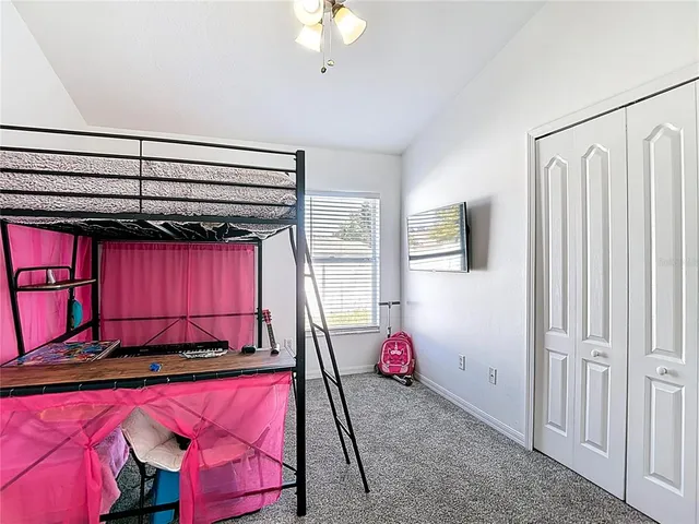 a bedroom with a bed and a fan