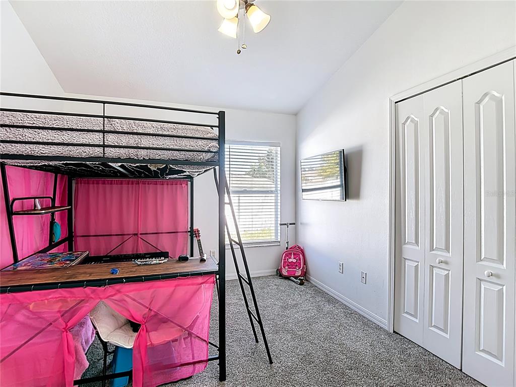 12153 South Bridge Terrace Hudson, FL 34669 - Photo 35 of 60 a bedroom with a bed a window and flowerpot