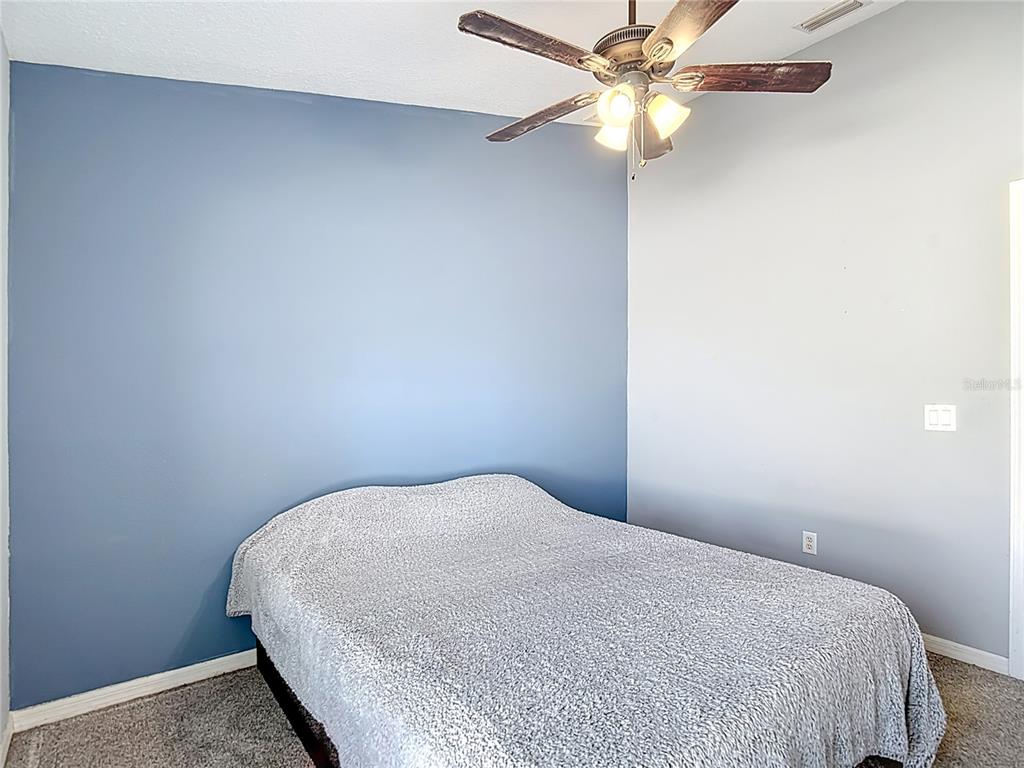 12153 South Bridge Terrace Hudson, FL 34669 - Photo 41 of 60 a bedroom with a bed and a fan