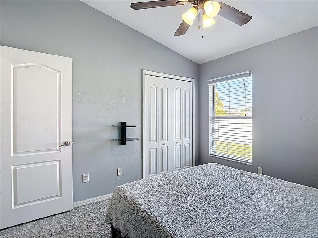 12153 South Bridge Terrace Hudson, FL 34669 - Photo 43 of 60 a bedroom with a bed and a chandelier